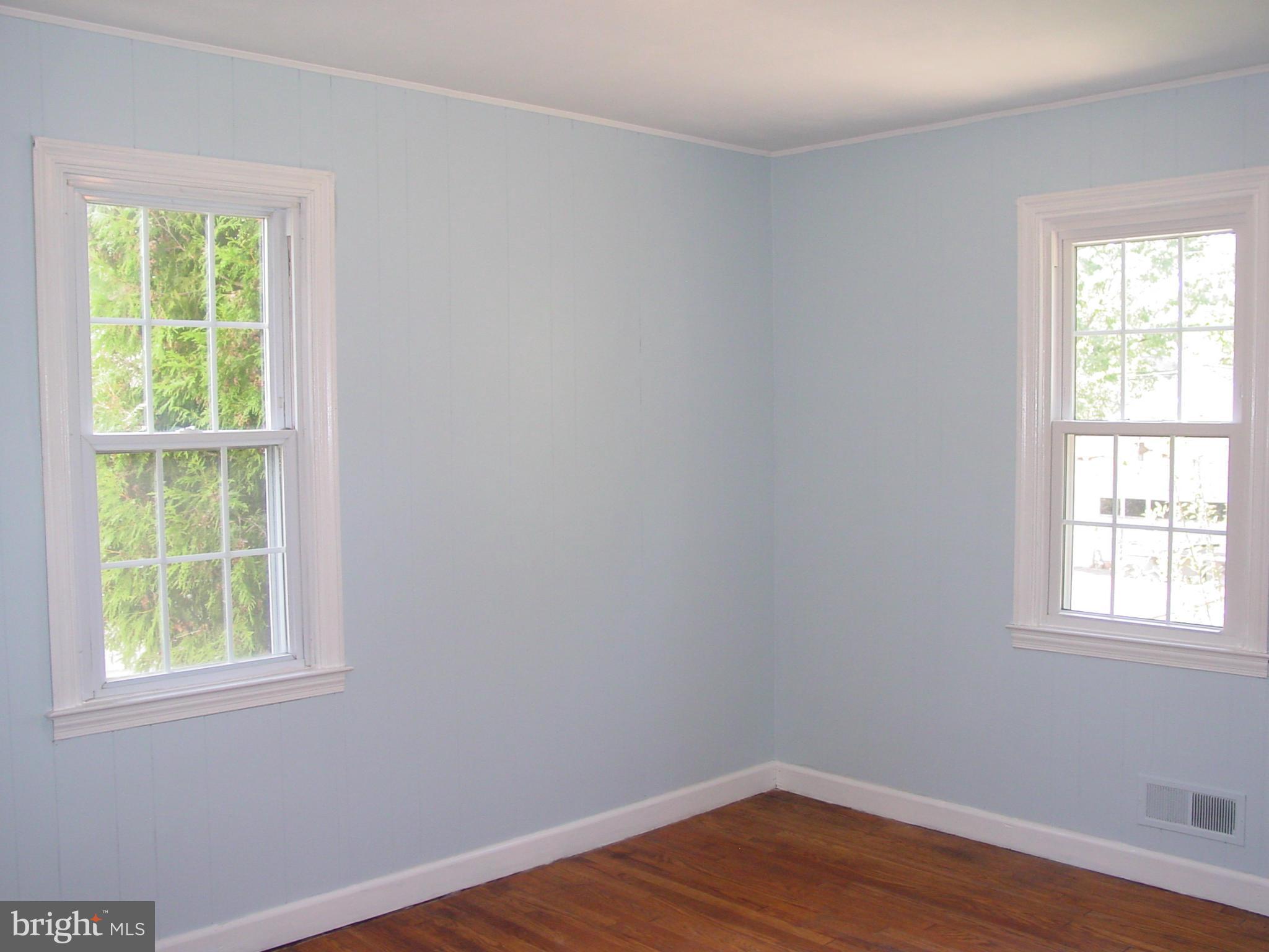 7912 Ridgely Oak Road Baltimore, MD 21234 - Photo 8 of 20 a view of an empty room with wooden floor and a window