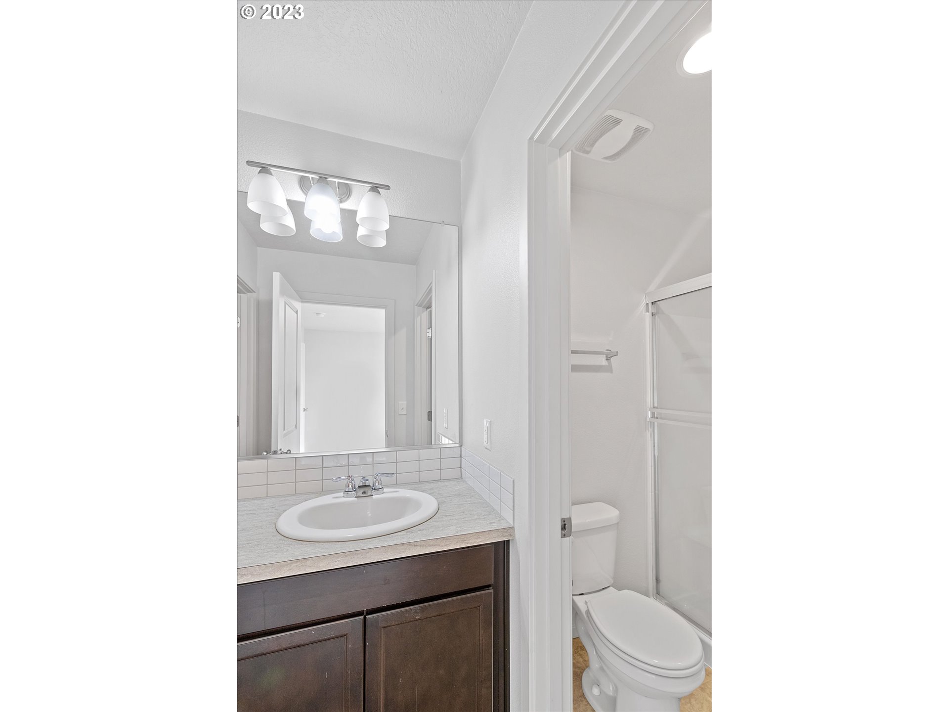 2240 Southeast 16th Street Gresham, OR 97080 - Photo 28 of 36 a bathroom with a sink a toilet and a mirror