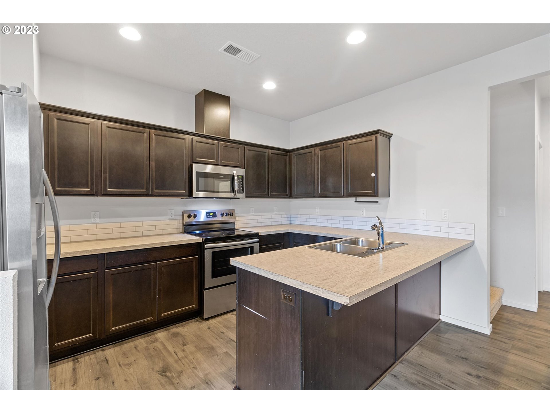 2240 Southeast 16th Street Gresham, OR 97080 - Photo 6 of 36 a kitchen with stainless steel appliances granite countertop a sink stove and microwave