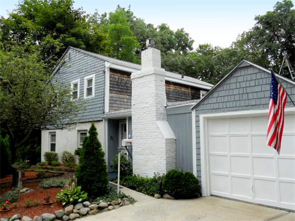 2 Border Road Natick, MA 01760 - Photo 1 of 15 a front view of a house with garden