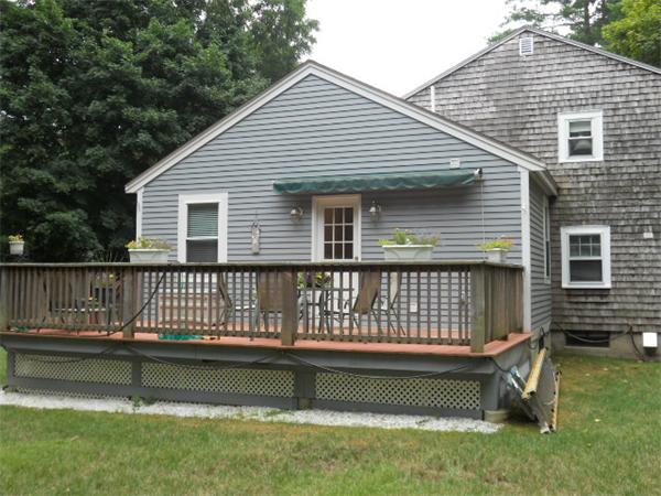 2 Border Road Natick, MA 01760 - Photo 13 of 15 a front view of a house with a garden and swimming pool