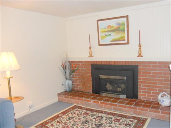 2 Border Road Natick, MA 01760 - Photo 3 of 15 a living room with furniture and a fireplace