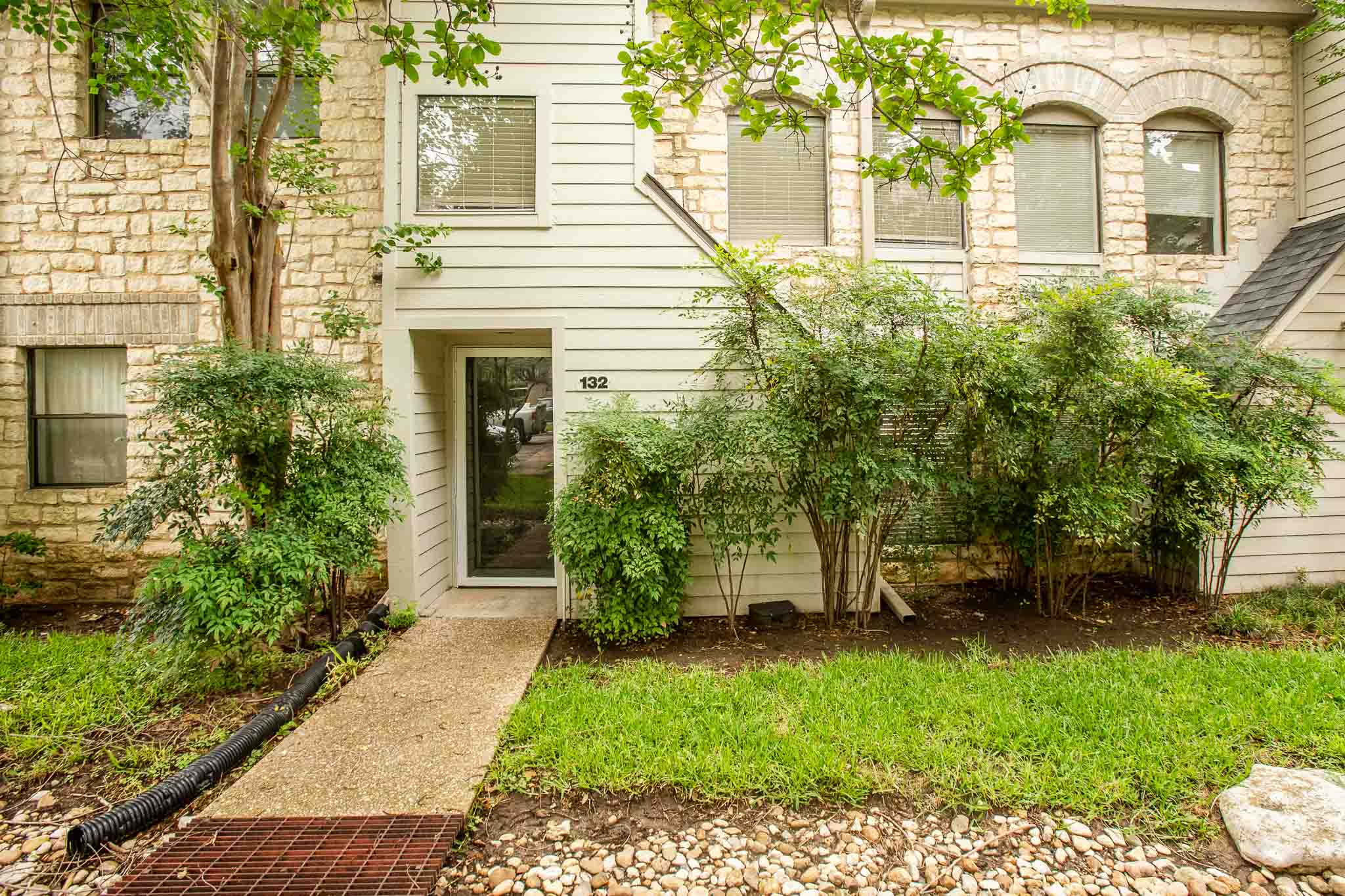 A welcoming front entrance, adorned with lush greenery, offers inviting curb appeal.