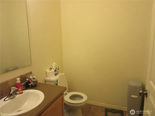 a bathroom with a sink a toilet and a mirror