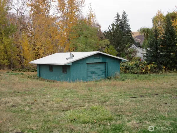 a backyard of a house with table and chairs