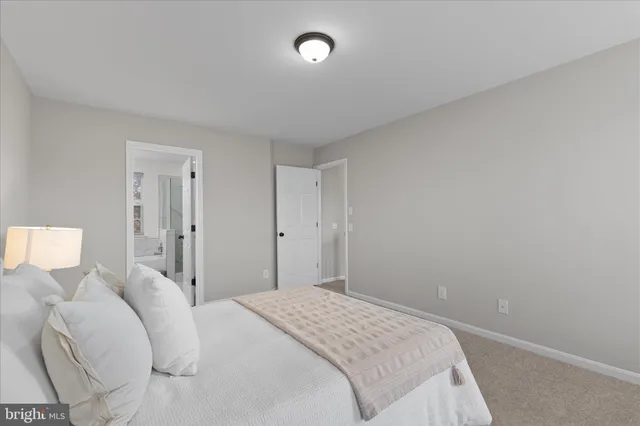 a bedroom with a bed and a lamp