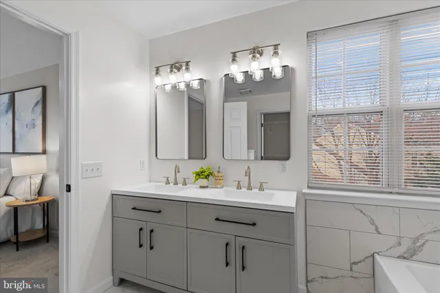 a bathroom with a double vanity sink and a mirror