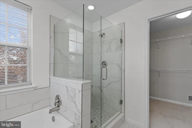 a bathroom with a shower and a sink