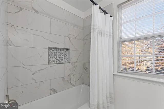 a bathroom with a shower and a bathtub