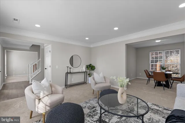 a living room with furniture a rug and a window