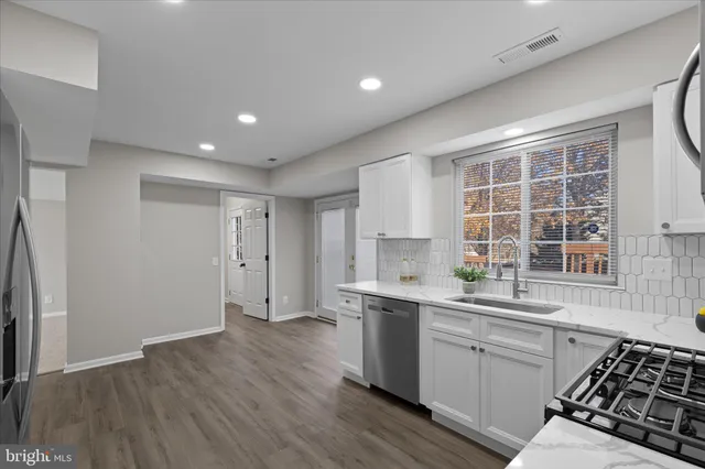 a kitchen with a sink stove and cabinets