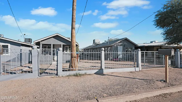 a view of a house with wooden fence