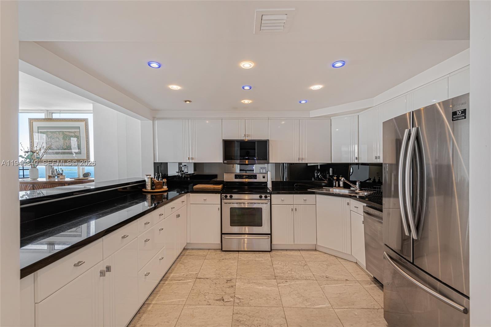 600 Northeast 36th Street, Unit PH1 Miami, FL 33137 - Photo 12 of 41 a kitchen with granite countertop stainless steel appliances and counter space