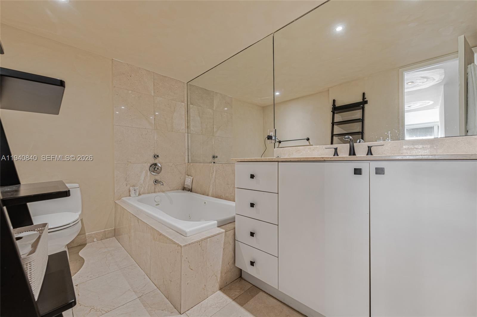 600 Northeast 36th Street, Unit PH1 Miami, FL 33137 - Photo 15 of 41 a bathroom with a sink a toilet a mirror and vanity