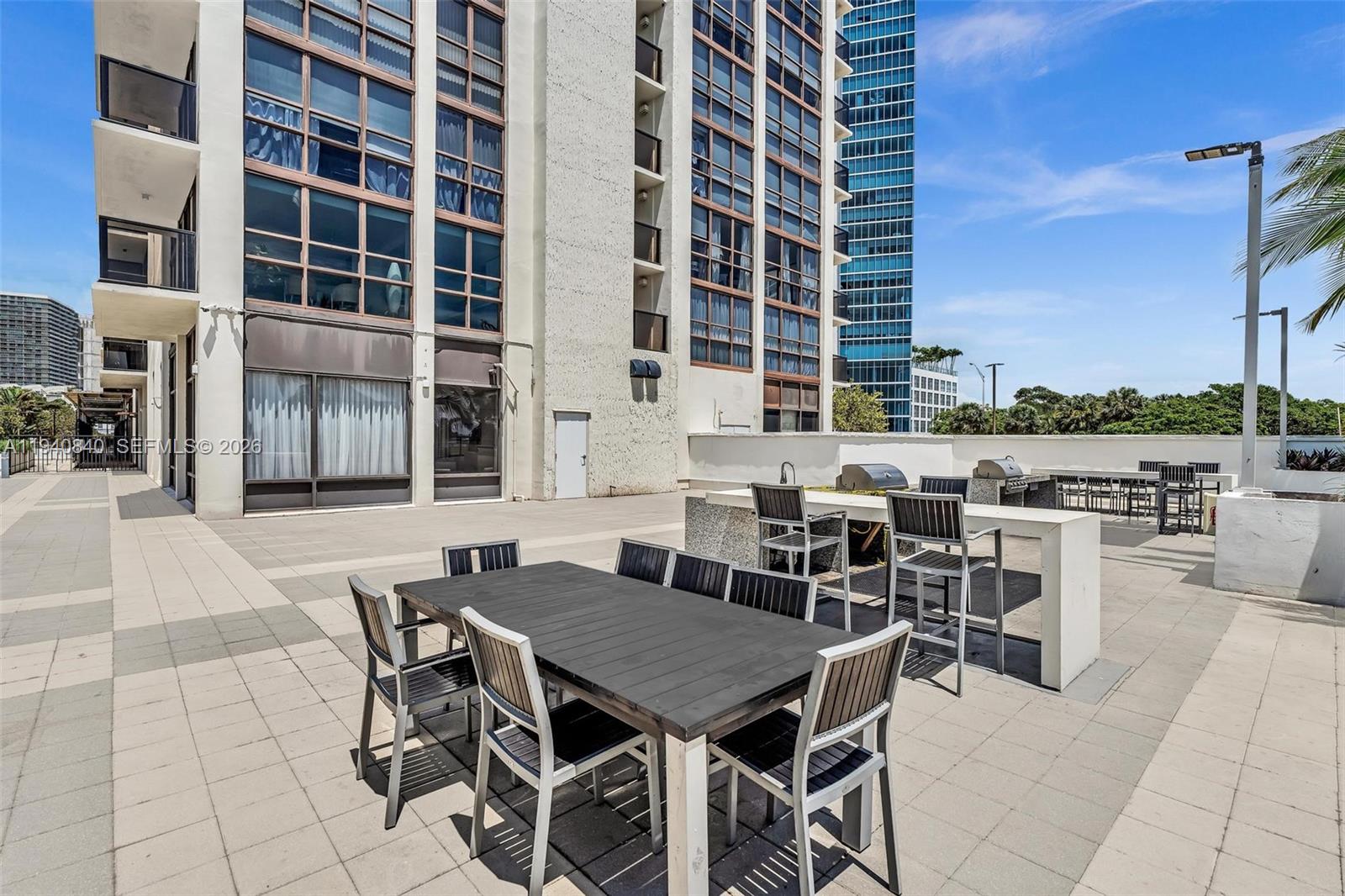 600 Northeast 36th Street, Unit PH1 Miami, FL 33137 - Photo 37 of 41 a view of a dinning table and chairs in the patio