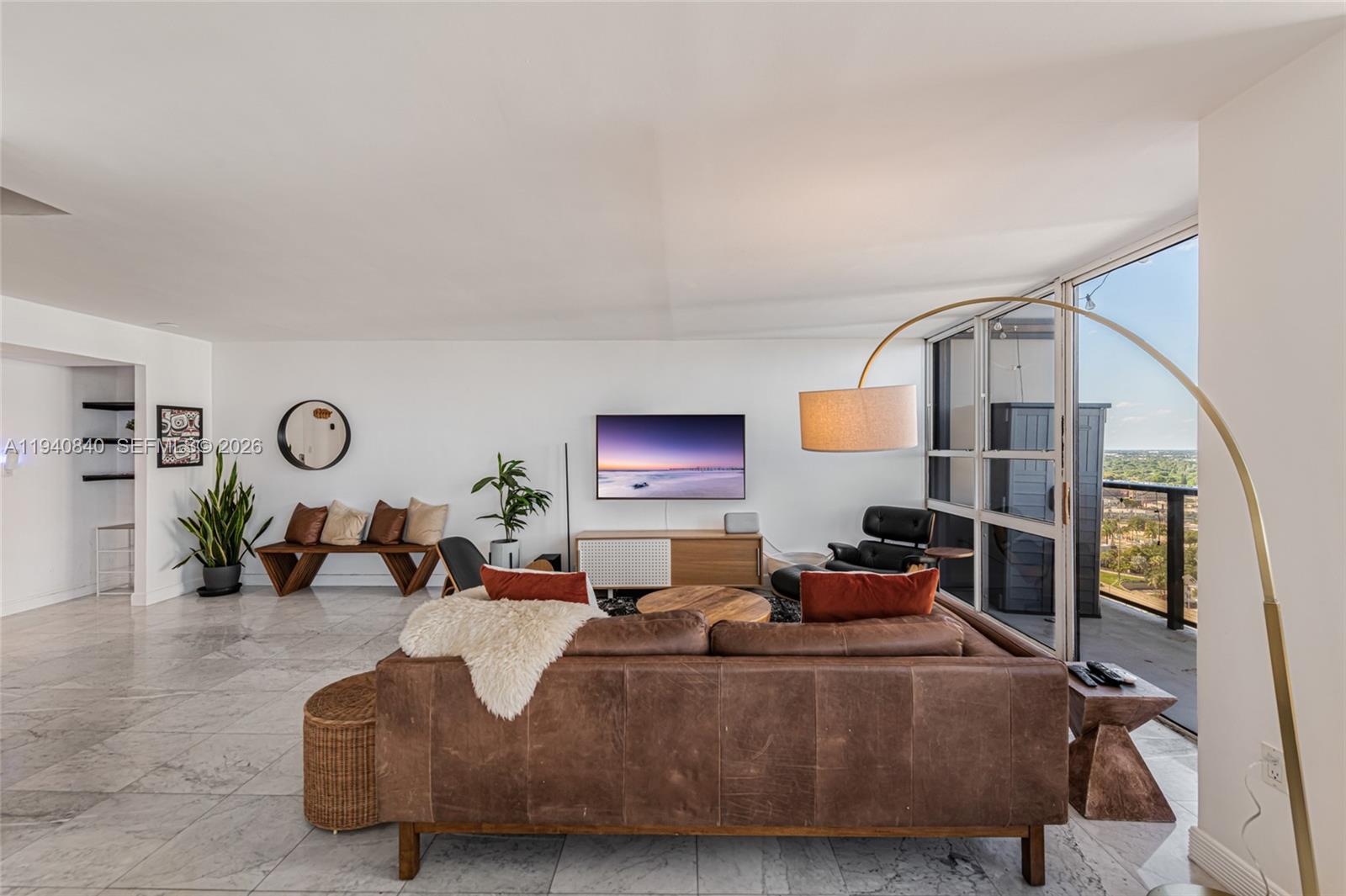 600 Northeast 36th Street, Unit PH1 Miami, FL 33137 - Photo 8 of 41 a living room with furniture and a flat screen tv