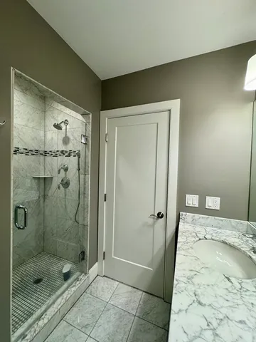 a bathroom with a shower and a sink