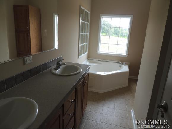 131 Timber Ridge Rutherfordton, NC 28139 - Photo 7 of 11 a bathroom with a tub sink and mirror