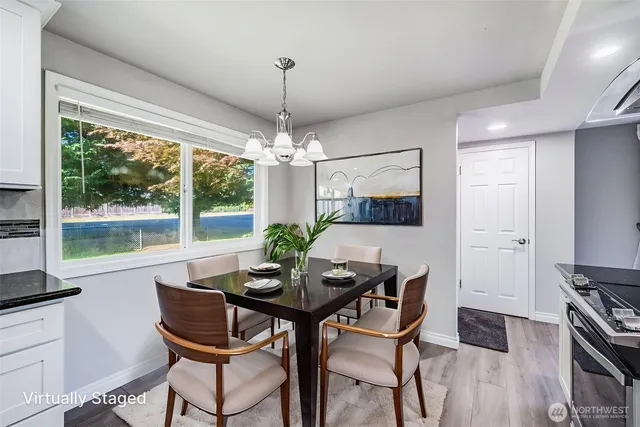 a view of a dining room with furniture window and wooden floor