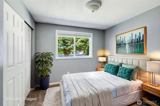 a bedroom with a bed and a window