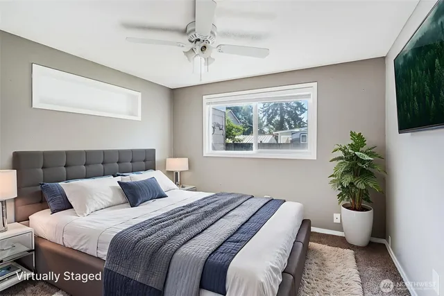 a bedroom with a large bed and a potted plant