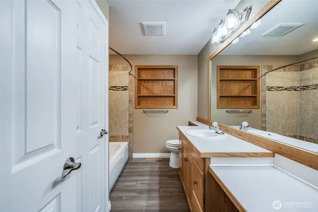 a bathroom with a sink a vanity and a large mirror