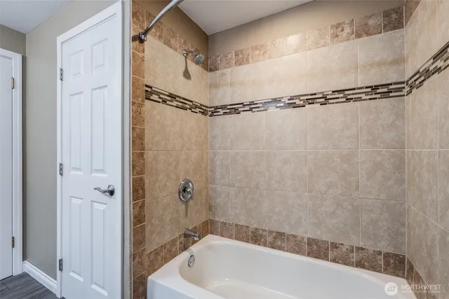 a bathroom with a shower and a bathtub
