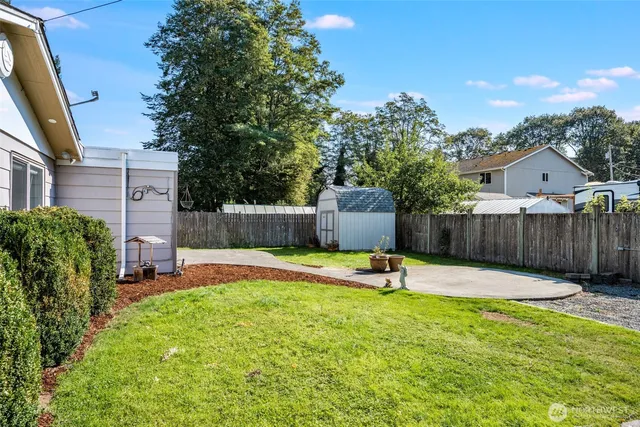 a swimming pool with a bench and trees