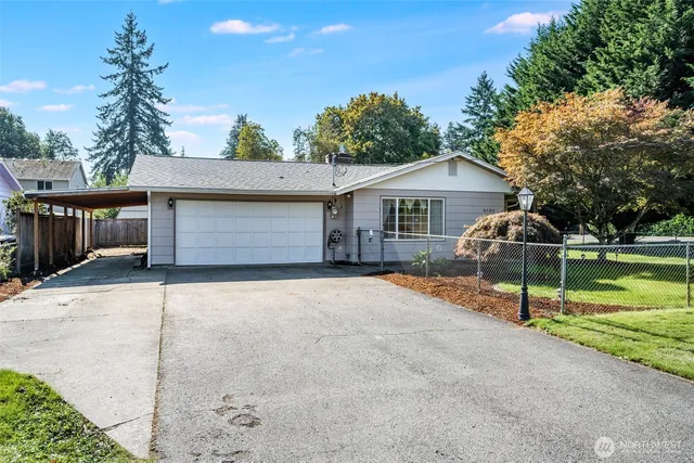 a front view of a house with a yard garage and outdoor seating