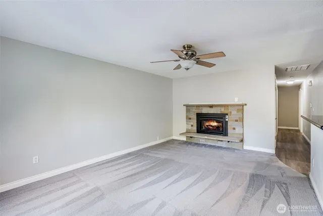 a view of an empty room with a fireplace
