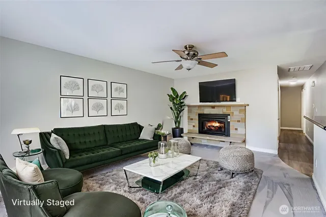 a living room with furniture a fireplace a flat screen tv and a fireplace