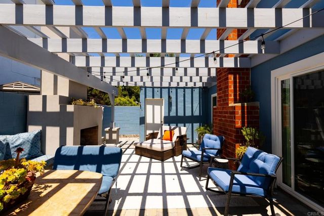 a view of a patio with couches table and chairs and potted plants