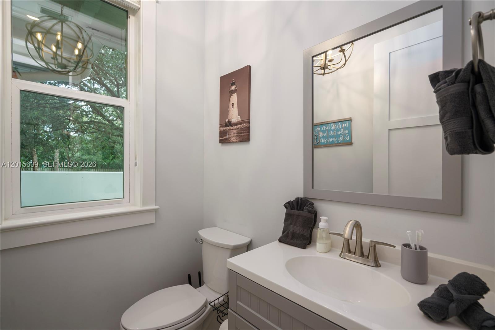 545 Southwest Indianola Street Stuart, FL 34994 - Photo 18 of 64 a bathroom with a toilet sink and mirror