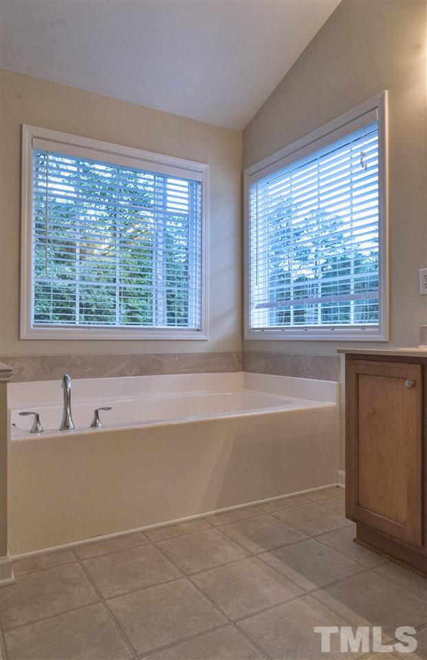 1017 Bianco Drive Raleigh, NC 27607 - Photo 8 of 13 a bath tub sitting in a bathroom next to a window