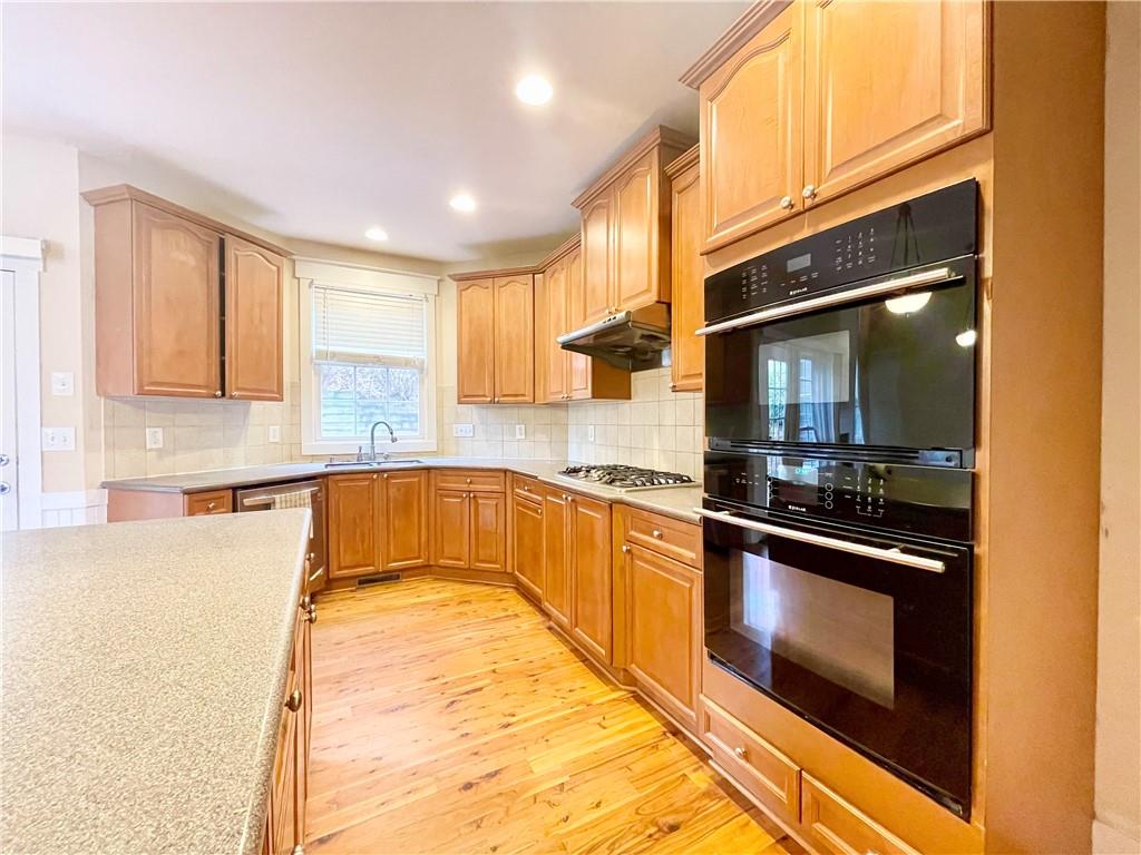 555 Vinings Springs Drive Southeast Mableton, GA 30126 - Photo 21 of 57 a large kitchen with stainless steel appliances granite countertop a stove and a sink