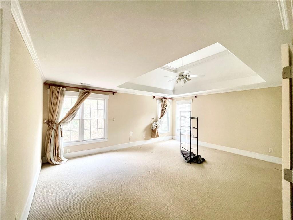 555 Vinings Springs Drive Southeast Mableton, GA 30126 - Photo 28 of 57 an empty room with windows and chandelier fan