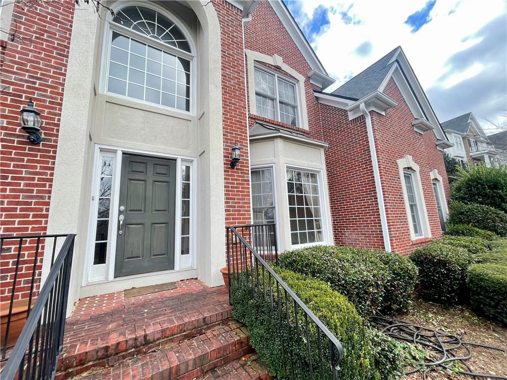 555 Vinings Springs Drive Southeast Mableton, GA 30126 - Photo 3 of 57 a view of a brick house with many windows