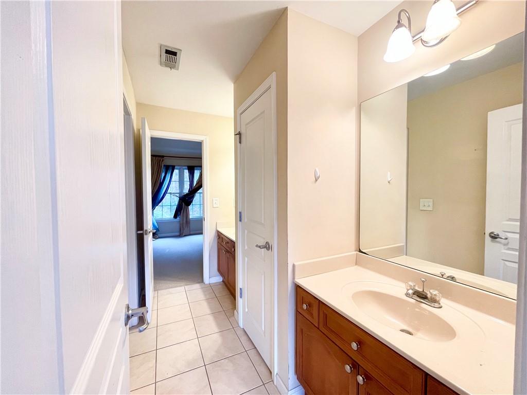 555 Vinings Springs Drive Southeast Mableton, GA 30126 - Photo 47 of 57 a bathroom with a sink a mirror and a toilet