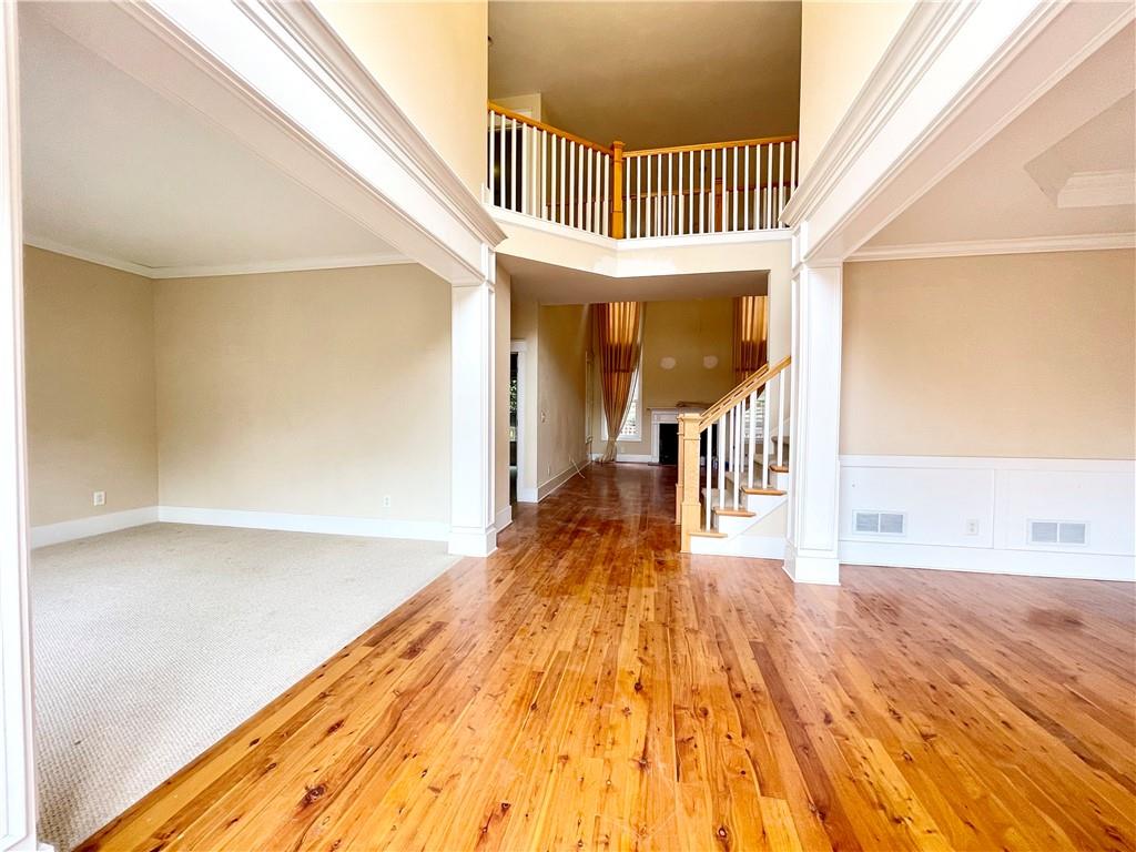 555 Vinings Springs Drive Southeast Mableton, GA 30126 - Photo 5 of 57 a view of a hallway with wooden floor and staircase