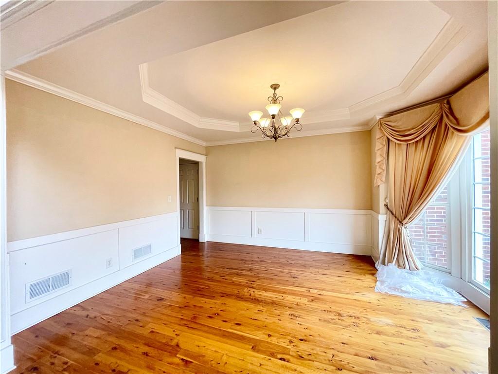 555 Vinings Springs Drive Southeast Mableton, GA 30126 - Photo 6 of 57 a view of an empty room with wooden floor and a window