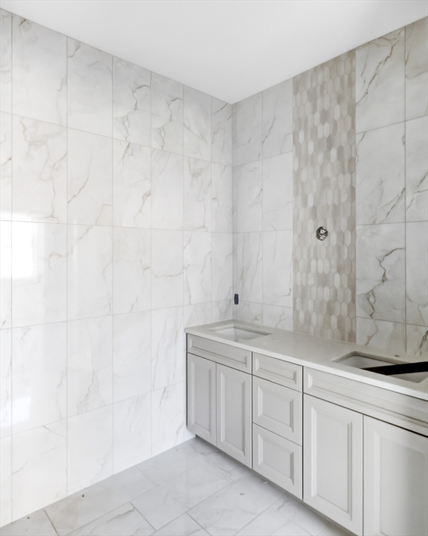 13 Elizabeth Lane, Unit 13 Easthampton, MA 01027 - Photo 13 of 26 a spacious bathroom with a granite countertop sink and a mirror