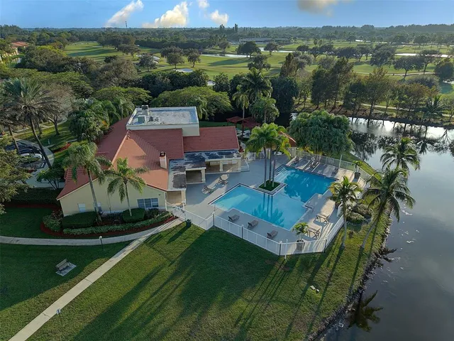 an aerial view of a house with a yard lake view and mountain view