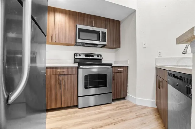 a kitchen with a stove top oven and sink