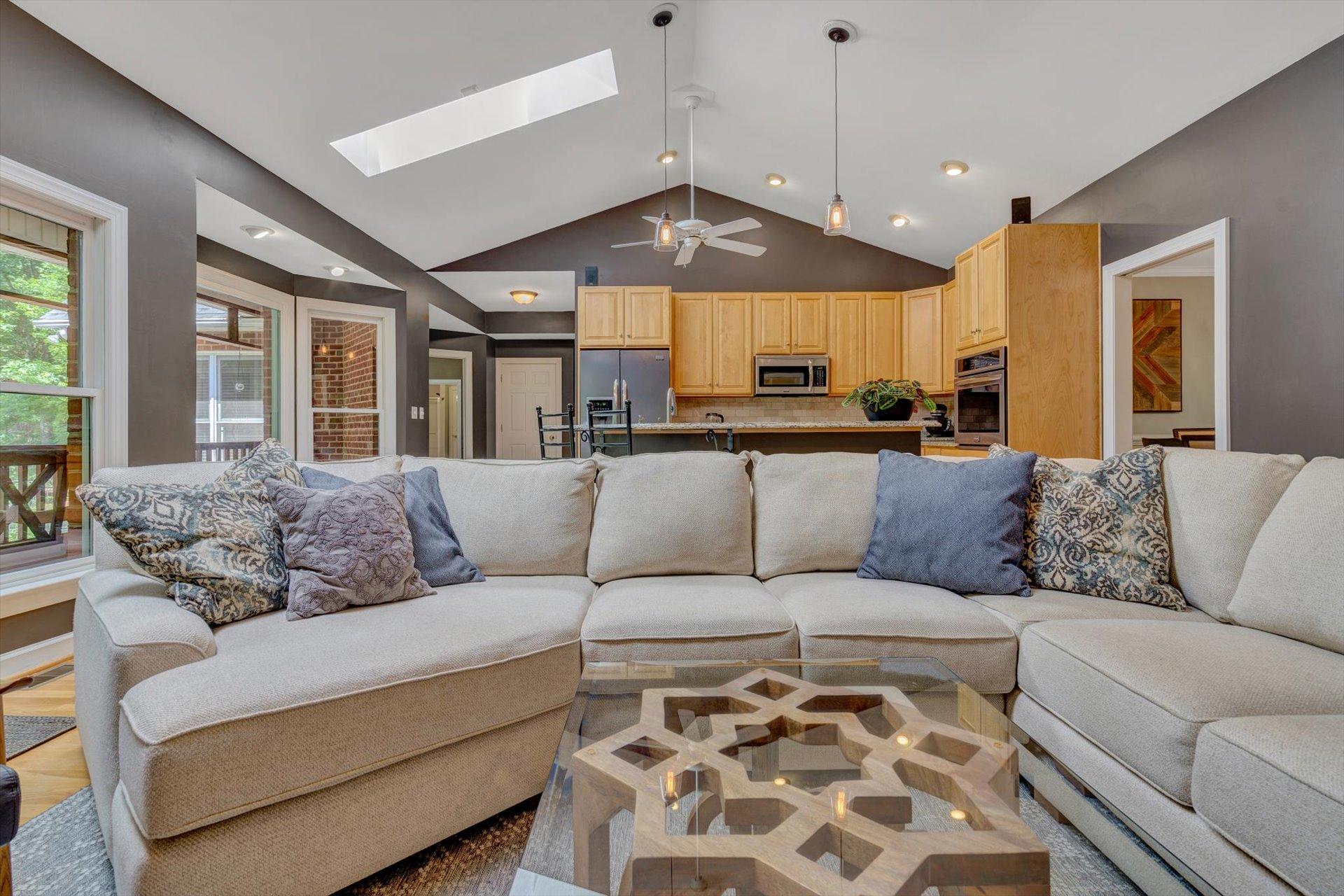 2795 New Ridge Road Elliston, VA 24087 - Photo 14 of 46 a large living room with a couch and a chandelier