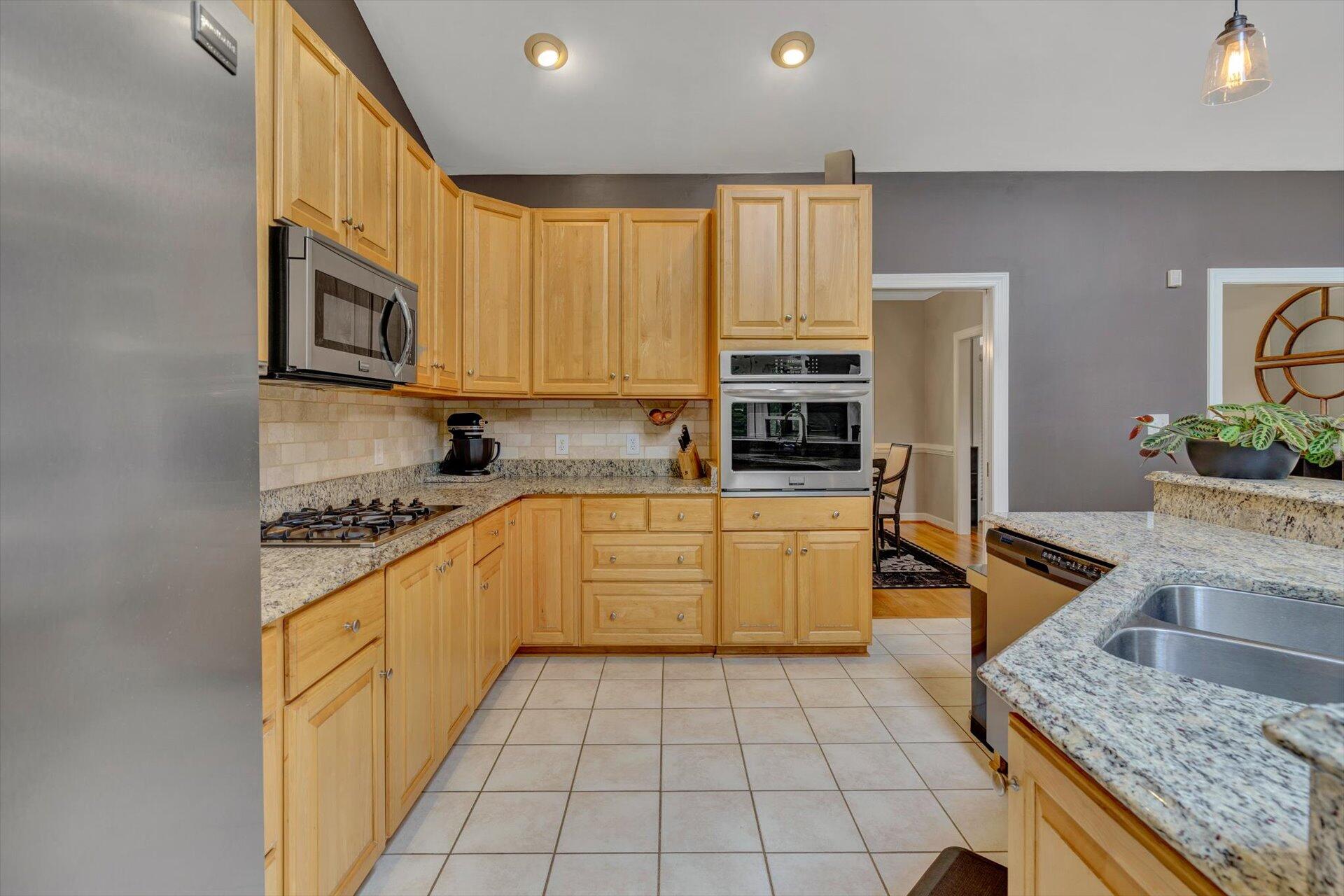 2795 New Ridge Road Elliston, VA 24087 - Photo 16 of 46 a kitchen with stainless steel appliances granite countertop a stove a sink and a microwave
