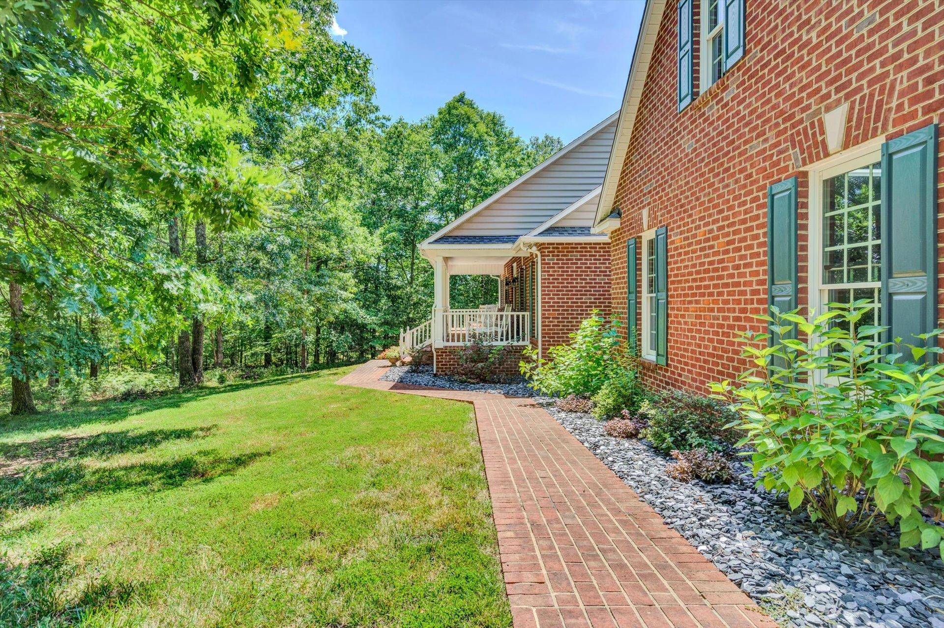 2795 New Ridge Road Elliston, VA 24087 - Photo 3 of 46 a front view of a house with garden