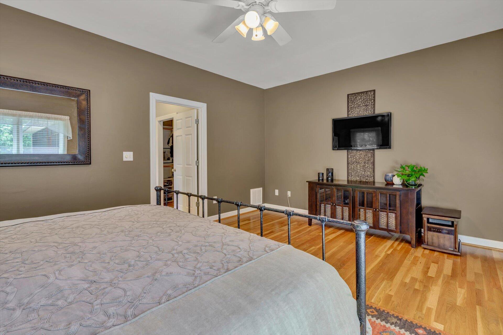 2795 New Ridge Road Elliston, VA 24087 - Photo 23 of 46 a bedroom with a bed and a flat tv screen on the dresser