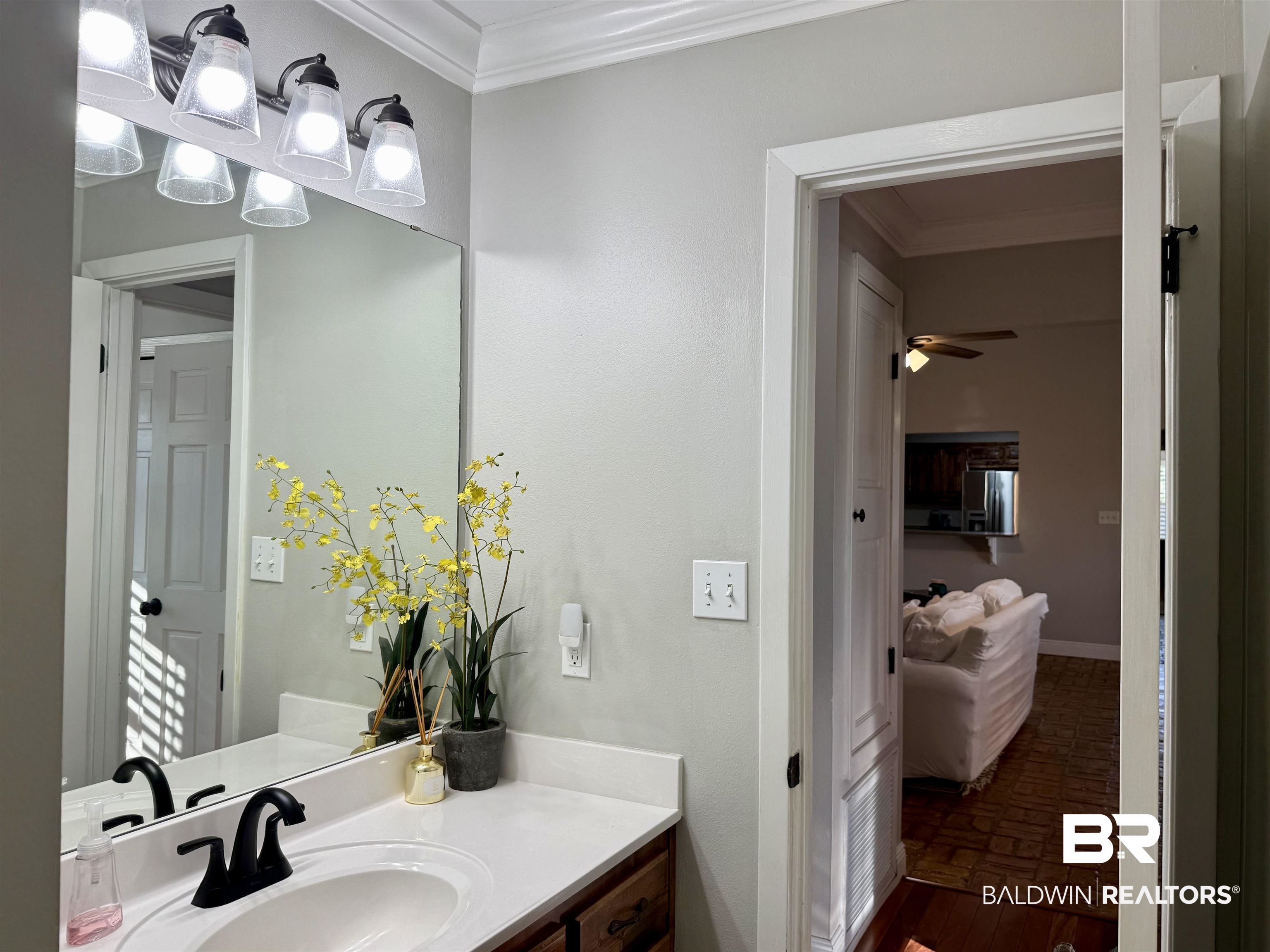5646 Foshee Road Brewton, AL 36426 - Photo 20 of 37 Bathroom featuring crown molding, vanity, and brick patterned flooring
