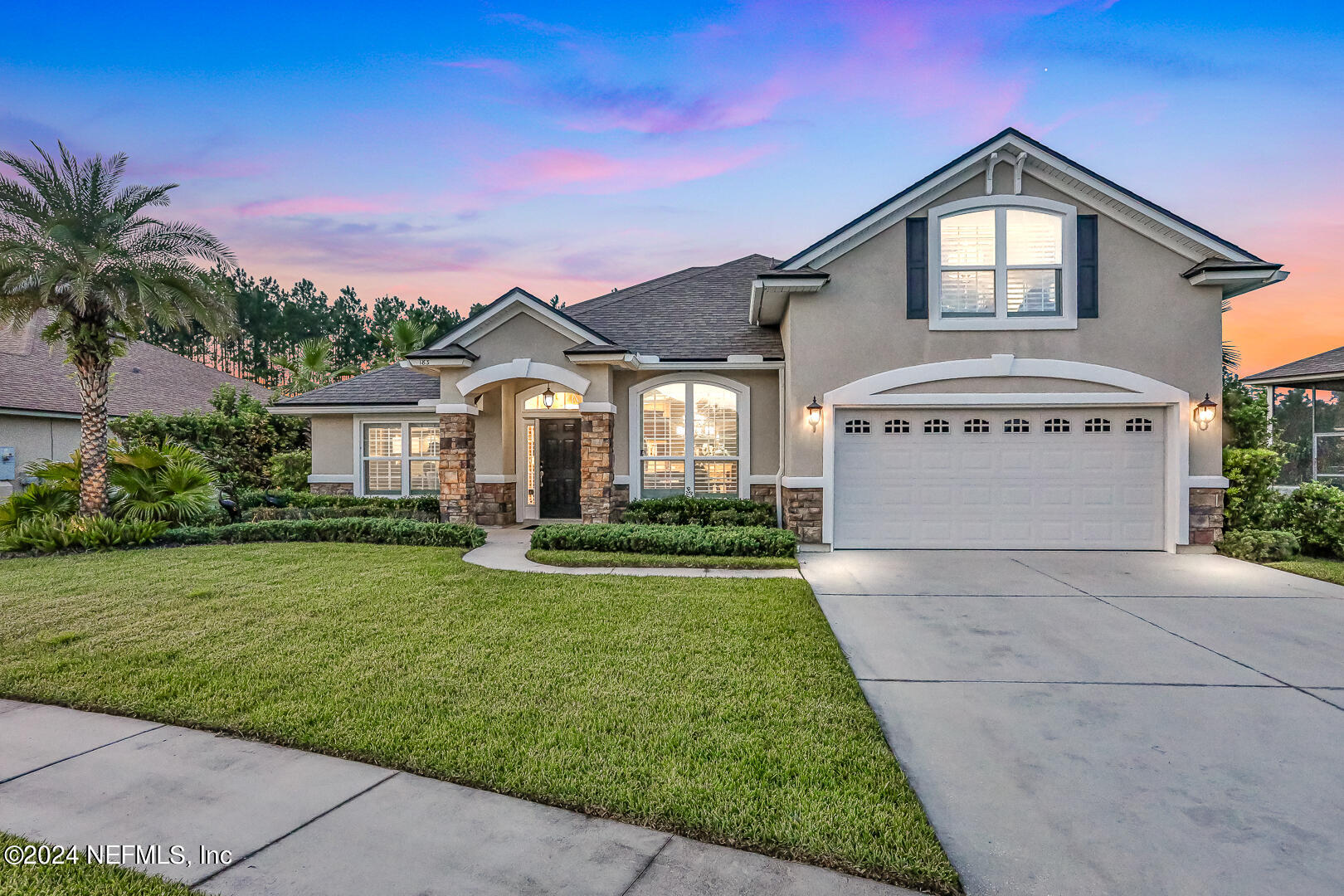 183 Flora Lake Circle St. Augustine, FL 32095 - Photo 1 of 40 a front view of a house with a yard