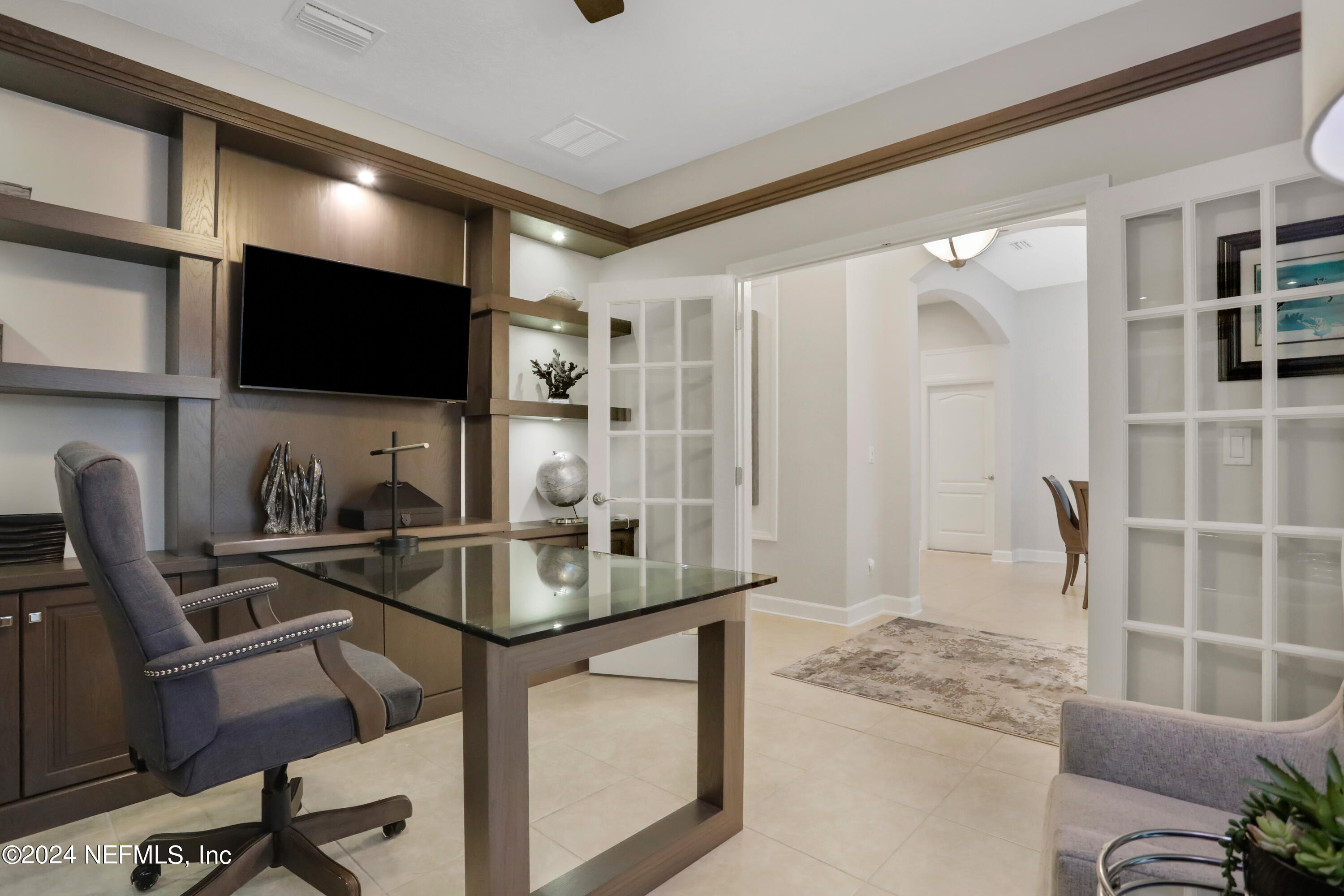 183 Flora Lake Circle St. Augustine, FL 32095 - Photo 15 of 40 a work room with furniture and a flat screen tv